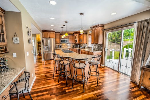pexels-photo-534151-534151 A luxurious modern kitchen featuring hardwood floors and granite countertops.